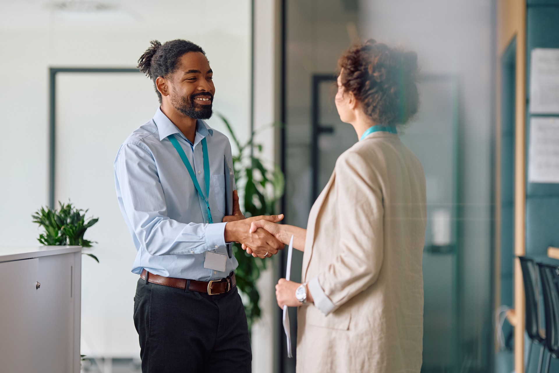 Happy black job candidate shaking hands with female CEO in the office.